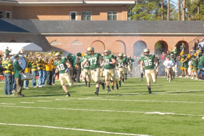 The Tribe football team runs out of the locker rooms at the start of one of their home games. (Photo by Philip Delano - The Flat Hat)