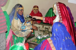 A women reenacts regional dowry traditions for the host of the nightly live program from the festival:  Asala!