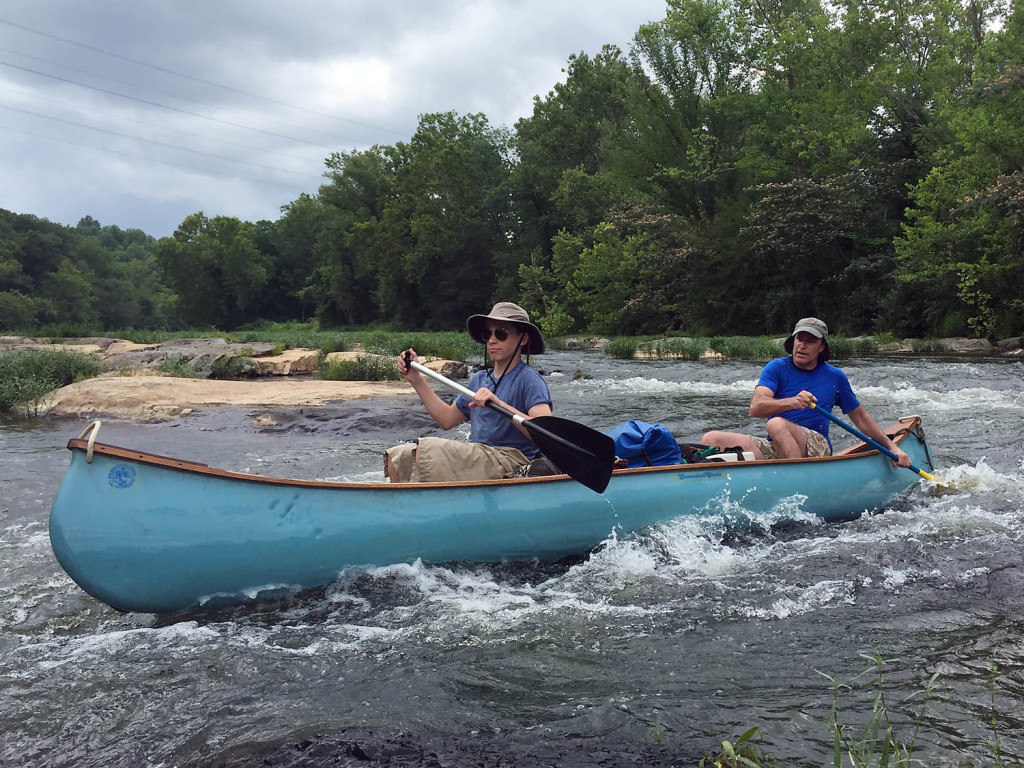 Stuart and Todd Beach slicing through rapids on the Rivanna River near Monticello.