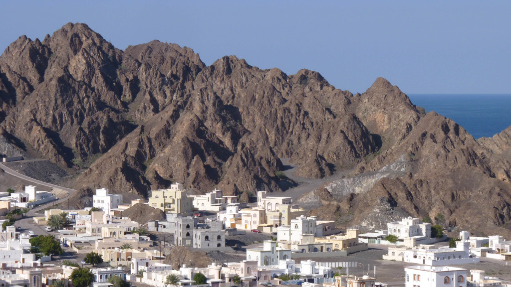 The village of Qantab, Oman with the waters of the Gulf of Oman visible in the distance. The craggy and steep hills are underlain by Cretaceous ophiolite. 