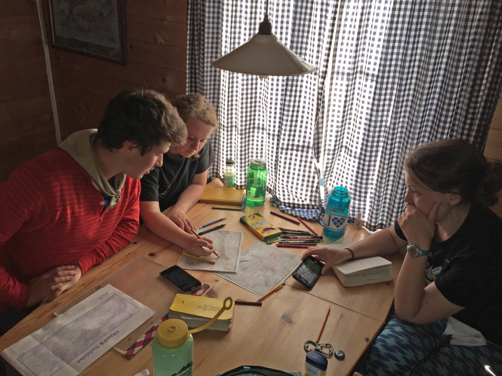 Josh Himmelstein, Katie Lang, and Hope Duke working late into the Arctic 'night' on their Trolldalen map.