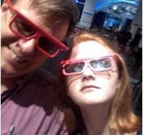 A father and daughter wearing IMAX theater glasses