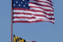 American and Maryland flags flying high over downtown Baltimore. Just why does the American flag have 15 stars and stripes? Think about Baltimore's Fort McHenry and Francis Scott Key.