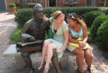 two students sitting with a Jefferson statue