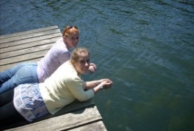 two students lie on the dock at Lake Matoaka