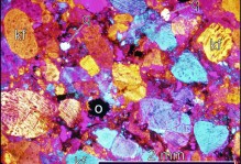 Micrograph of arkosic arenite from near Monticello. Note well-developed clastic texture with rounded to subangular clasts. kf- K-feldspar, q- quartz, o- opaque minerals. Cross polarized light with interference plate.