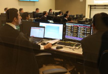 Students in suits at computers in the Mason School of Business