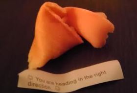 a fortune cookie with the fortune that reads, "You are heading in the right direction"