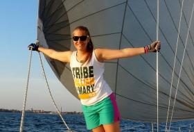 Cassidy Fazio poses on a sailboat for club sailing