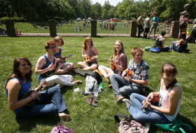 students play ukuleles on the sunken gardens