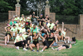 a group of Deans vs. Interviewers after kickball sitting on the steps of the sunken gardens