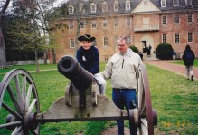 a young child on a cannon in front of the wren building