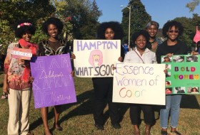 Some of the members of E.S.S.E.N.C.E Women of Color at homecoming 2015. We were playing Hampton University, hence the signs. Can you guess the theme these ladies are dressed to?