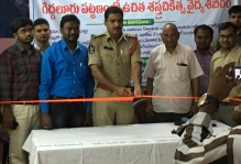 Opening ceremony of the medical camp by a police officer with doctors surrounding him.