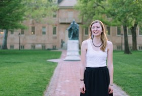 A picture of Anne Davis '16 in front of the wren building