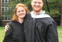 a man and woman pose together in their graduation outfits