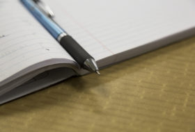 A pen in the crease of a composition book