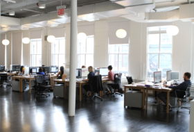 Employees seated at their desks in the office for Trollback+Company