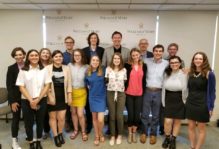Former FBI Director and William and Mary alum James Comey poses with the News & Media Institute. Standing in front of him at center is Kyra, who later said, "You could fit another half of me on top and I still wouldn't be as tall as him!"