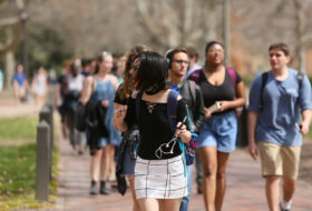 Students walking to and from class on brick pathway
