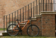 a bike leaned up against a brick stairwell