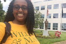 William and Mary student takes a selfie in front of a statue