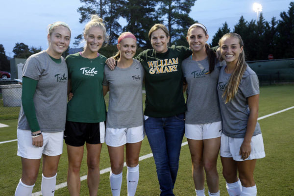 Coach Jill Ellis '88 posing with current players of the Tribe women's soccer team in 2015.