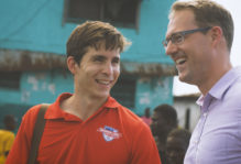 Will Smith '14 and Professor Phil Roessler smiling and talking together in Africa