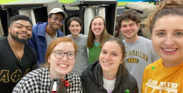 Group of students volunteering, smiling in a group
