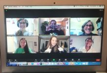Zoom call with six smiling people in the video window