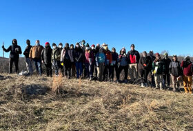 W&M geologists strike a pose in a cow pasture.