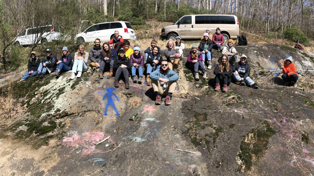 Students at a large outcrop