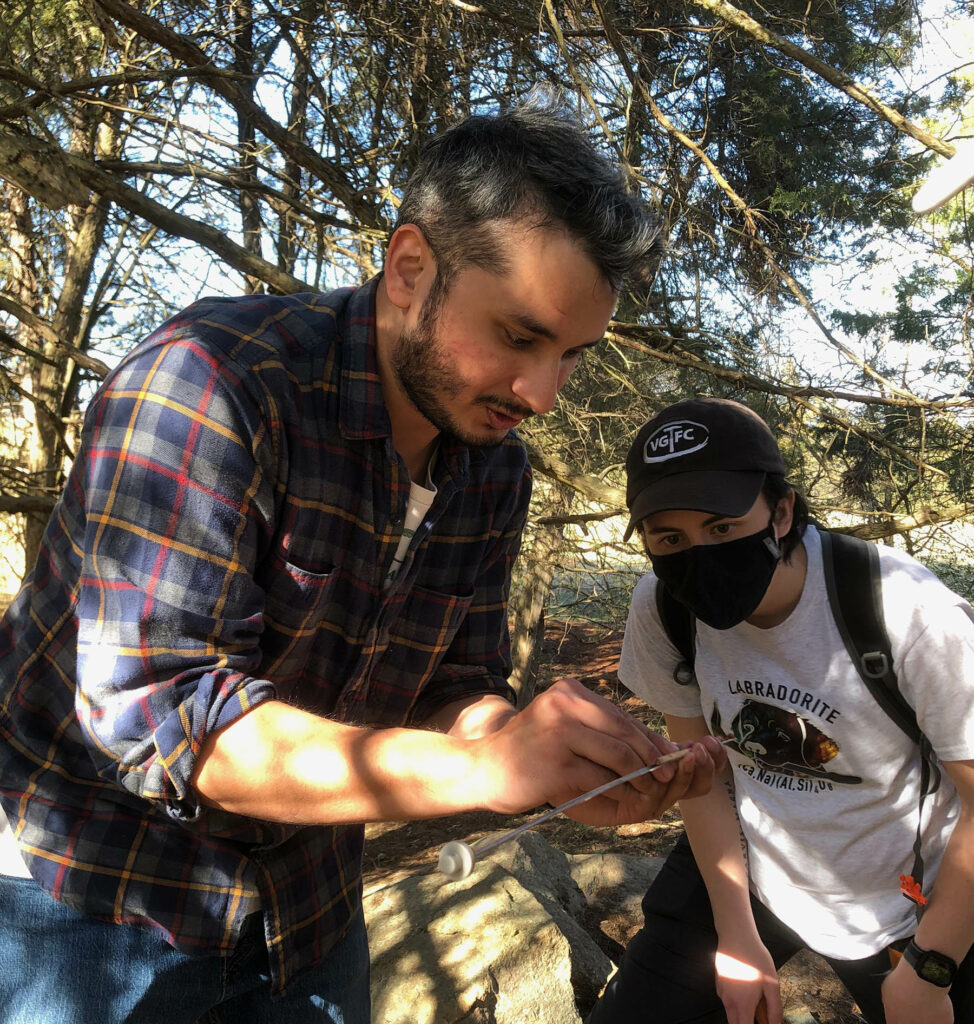 Faculty and students examining a tree core.