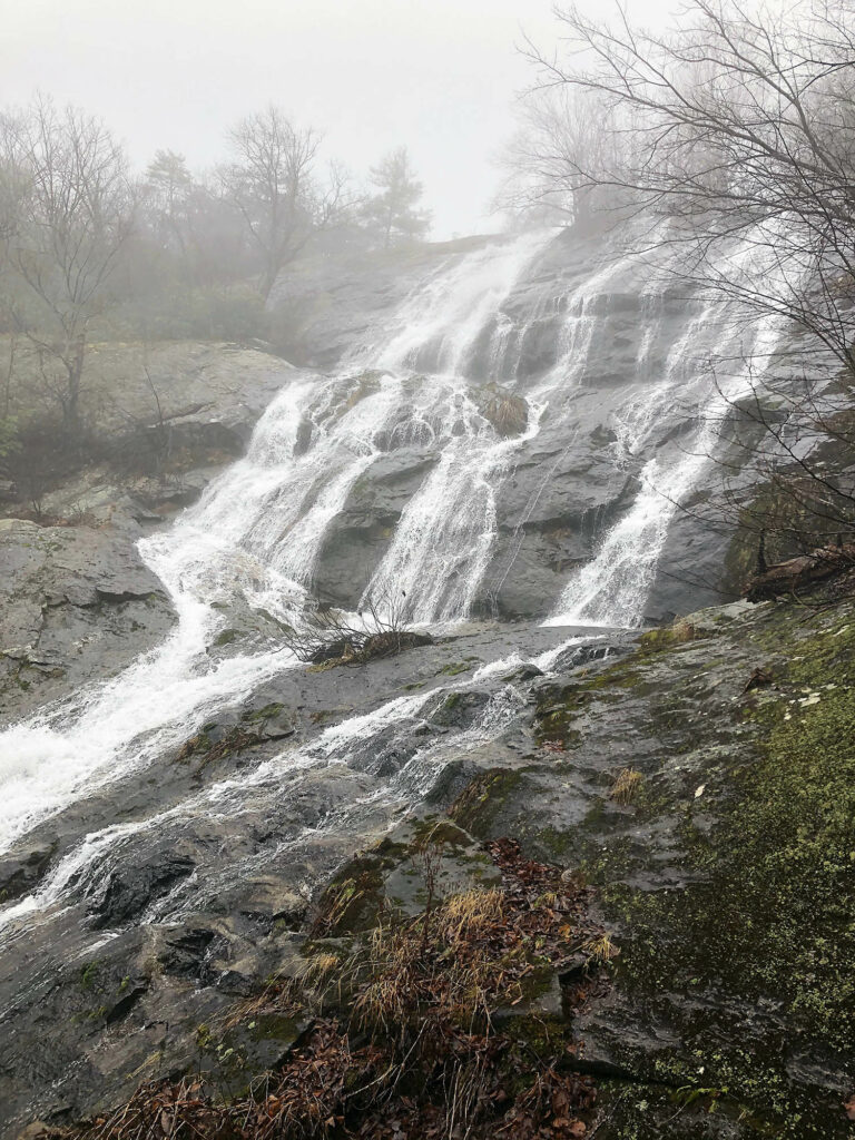 Water cascading down rocks on a misty day in winter
