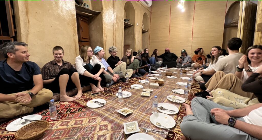 Dining, seated on the floor in the traditional Omani fashion in Nizwa, Oman.