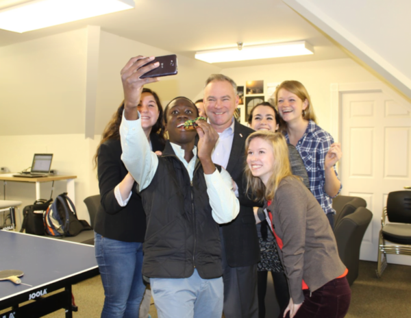 Smiling student researchers pose for a selfie with Tim Kaine 